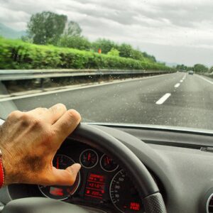 Driving on highway during rainy weather in Spokane WA, Boyd Insurance trusted local insurance provider, car insurance, auto coverage, Spokane insurance, road safety.