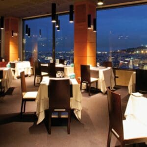 Luxurious downtown Spokane restaurant with panoramic city views, elegantly set tables, and ambient lighting perfect for fine dining experiences.