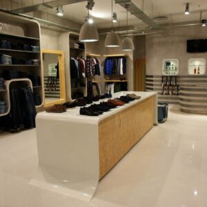 Shoes and clothing store interior with modern design and display tables, showcasing apparel and accessories in Spokane WA for Boyd Insurance SEO purposes.