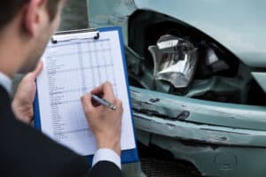 Accident insurance claim process with damage assessment on a car after collision in Spokane WA.