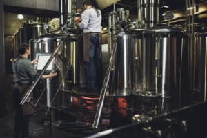 Brewing equipment at a brewery, showcasing stainless steel tanks for beer production in Spokane, WA.